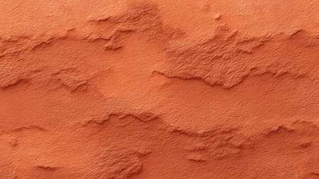 This image features a close-up view of a textured orange clay surface, showcasing unique patterns that create an earthy and warm ambiance perfect for creative projects.の素材