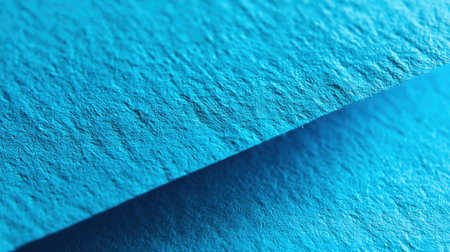 A close-up view of vibrant blue paper with a rich texture, perfect for graphic design, artistic projects, or as an eye-catching backdrop for creative works.の素材