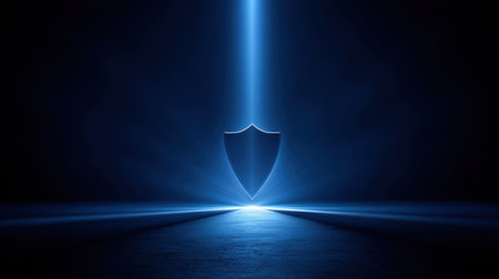 This image features a shield symbol illuminated by a striking blue light beam against a dark backdrop, ideal for conveying concepts of security and protection.の素材