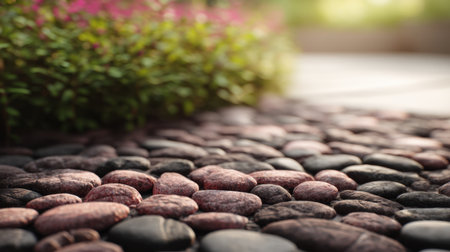 A serene garden pathway lined with smooth stones and soft greenery creates a peaceful outdoor atmosphere, inviting relaxation and tranquil moments in nature.の素材