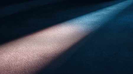 This photo captures soft beams of light cutting through darkness, creating a mesmerizing effect on the textured surface below, perfect for artistic themes and projects.の素材