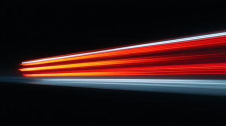 Capture the essence of speed and motion in this stunning image of light trails from vehicles on a dark road, showcasing vibrant colors and dynamic energy.の素材