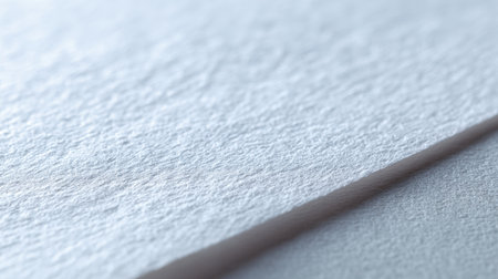 This close-up image showcases a textured white paper surface, highlighting subtle shadows and light reflections, ideal for design and artistic applications.の素材
