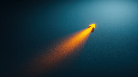 This image features an orange arrow casting a dramatic shadow on a textured blue wall, symbolizing direction and movement with a striking visual contrast and modern aesthetic.の素材