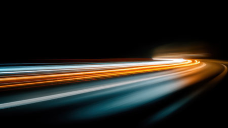 This captivating image showcases vibrant light trails against a dark backdrop, emphasizing the movement and energy of nighttime travel in an artistic manner.の素材