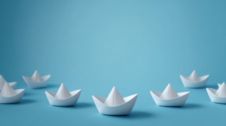 This image features small white paper boats gently floating against a calming blue background, symbolizing creativity and nostalgia, perfect for various creative projects.の素材