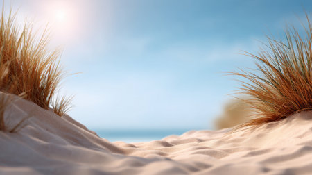 A peaceful beach scene featuring soft sand dunes adorned with coastal grass under a bright blue sky. The gentle sunlight creates a serene ambiance, perfect for relaxation.の素材