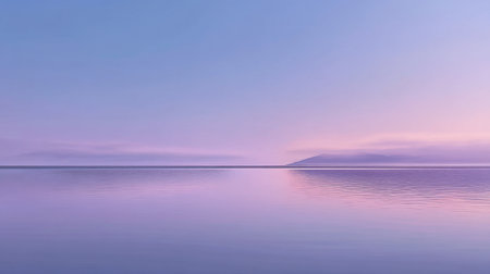 This image captures a serene horizon at dusk, showcasing soft blue and purple tones reflected on a calm water surface, creating a tranquil atmosphere.の素材