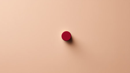 This minimalistic image showcases a single red circular object centrally placed on a soft beige background, creating a striking contrast and inviting focus.の素材