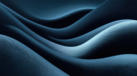 This abstract image showcases smooth waves of soft blue fabric, capturing the elegance and fluidity of textile textures highlighted by natural light.の素材
