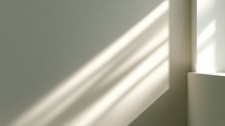 Captivating interplay of soft light and shadows on a minimalist wall creates a tranquil ambiance. Ideal for modern interior design, showcasing simplicity and elegance.の素材