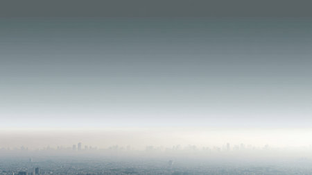 A tranquil urban skyline captured at dusk, showcasing a gradient from deep blue to a lighter hue, merging with a light fog that envelops the cityscape.の素材