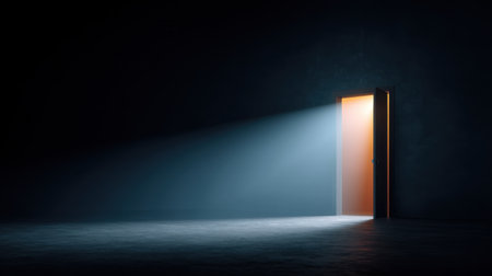 An open door casts a warm light beam into a darkened room, creating a vivid contrast between light and shadow, symbolizing hope and new beginnings in an intriguing setting.の素材