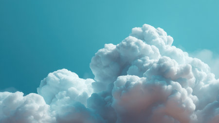 A stunning display of soft, fluffy white clouds set against a vibrant blue sky, complemented by subtle pink hues. Ideal for use in nature-inspired designs.の素材