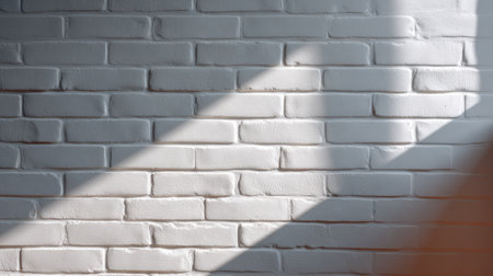 A bright and airy image featuring a textured white brick wall with sunlight casting soft shadows, perfect for modern interior design and minimalist spaces.の素材