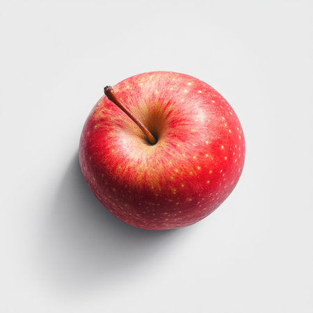 Isolated apple with detailed texture on a white background, minimal shadowの素材