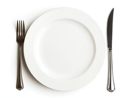 Isolated empty dinner plate with fork and knife, placed neatly on whiteの素材