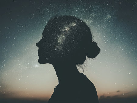 Double exposure night sky with a person, stars and galaxies blending into a silhouetteの素材
