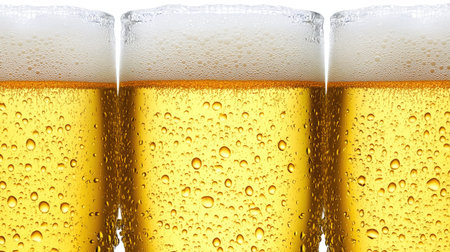 A close-up view of cold golden lager being poured into chilled glasses, showcasing the refreshing foam and bubbles. Perfect for summer celebrations.の素材