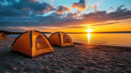 Enjoy a picturesque sunset with orange tents by a tranquil lakeshore. This image captures the essence of outdoor adventure and relaxation in nature.の素材