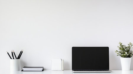 A modern minimalist workspace featuring a laptop, stationery, and plants. This design promotes productivity and organization, perfect for home or office settings.の素材
