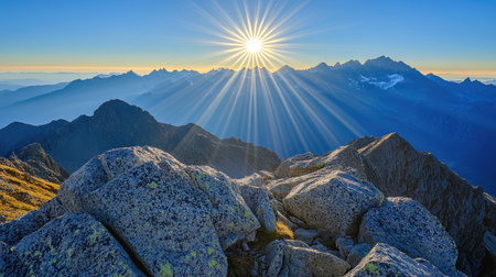 Stunning sunrise illuminating a breathtaking mountain landscape with vibrant rays of light. Majestic peaks and rocky foreground create a serene atmosphere.の素材