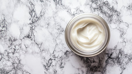 A creamy moisturizer in a silver container, placed on a beautiful marble surface, symbolizing luxury and freshness for an effective skincare routine.の素材