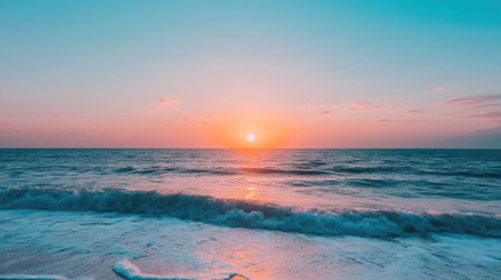A beautiful sunset casts warm colors over a tranquil ocean, creating a serene atmosphere. Gentle waves lap at the shore, inviting relaxation and reflection.の素材
