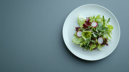 A vibrant mixed salad featuring greens and radishes, beautifully arranged on a white plate. Perfect for showcasing healthy eating and culinary presentation.の素材