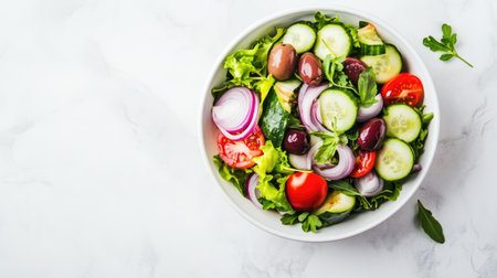 A vibrant and fresh vegetable salad featuring cucumbers, tomatoes, olives, and red onions, elegantly arranged in a white bowl, perfect for healthy meals.の素材
