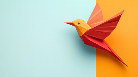 A vibrant origami bird crafted from colorful paper, displayed against a two-tone background of orange and blue. This artwork showcases creativity and elegance.の素材