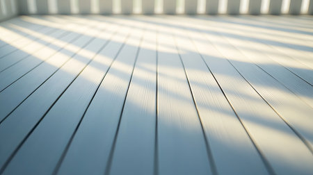 A serene indoor wooden floor capturing gentle light and shadow patterns, ideal for conveying a sense of calm and modern design in various projects.の素材