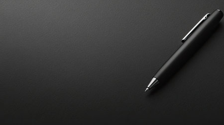 A sleek black pen rests on a dark surface, capturing the essence of professionalism and elegance. Ideal for business and creative projects.の素材