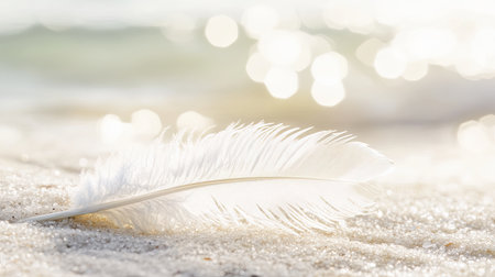A delicate white feather resting on sandy beach, surrounded by a tranquil atmosphere. Soft bokeh creates a serene backdrop, perfect for nature themes.の素材