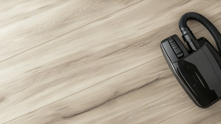 A sleek vacuum cleaner rests on a stylish wooden floor, showcasing modern design and practicality. Ideal for portraying cleanliness and home care themes.の素材