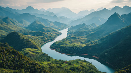 Breathtaking aerial view of a winding river surrounded by lush mountains, showcasing the beauty of nature in a tranquil and serene landscape.の素材