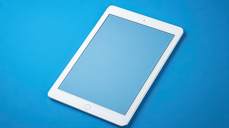 A sleek white tablet positioned on a vibrant blue background, perfect for showcasing technology, digital apps, or modern design concepts in various marketing materials.の素材