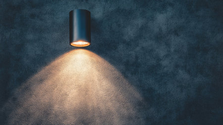 A modern wall light fixture casts a soft glow on a textured surface, creating a cozy atmosphere. Ideal for enhancing interior decor and ambiance.の素材