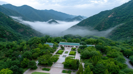 This stunning aerial view captures the lush green mountains enveloped in soft mist and clouds, creating a serene and tranquil atmosphere perfect for nature lovers.の素材