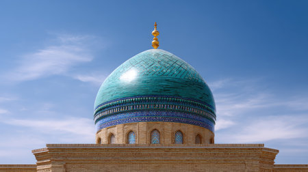 This stunning image captures a grand dome featuring vibrant turquoise hues and intricate patterns, set against a clear blue sky, embodying cultural and architectural beauty.の素材