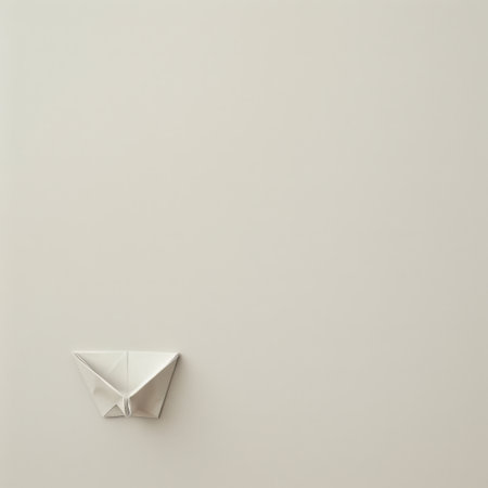 A minimalist origami boat rests on a soft, neutral background, capturing the art of paper folding. This image conveys creativity, simplicity, and tranquility.の素材