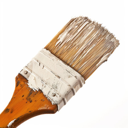 This image features a close-up of a paintbrush with white paint on its bristles, showcasing the details of the tool used in painting and crafting activities.の素材