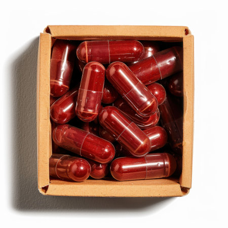 A collection of red capsules neatly packed in a light box, showcasing a vibrant arrangement on a clean background. Perfect for health and wellness themes.の素材