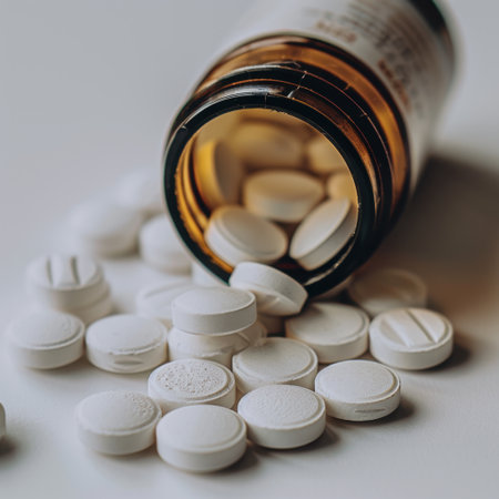 A detailed close-up image showcasing white tablets spilling from a brown glass bottle, emphasizing the pharmaceutical elements and health care themes.の素材