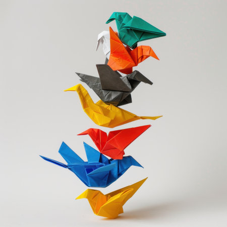 A vibrant display of colorful origami birds delicately stacked to create a balanced formation, representing artistry and creativity against a soft neutral backdrop.の素材