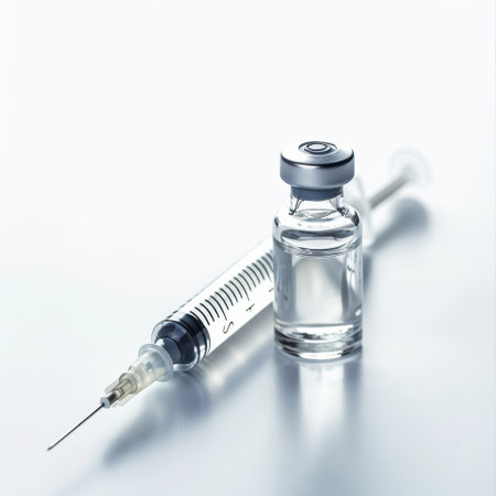 This image features a clear glass vial filled with liquid alongside a syringe. It symbolizes important aspects of healthcare, vaccination, and medical treatments.の素材