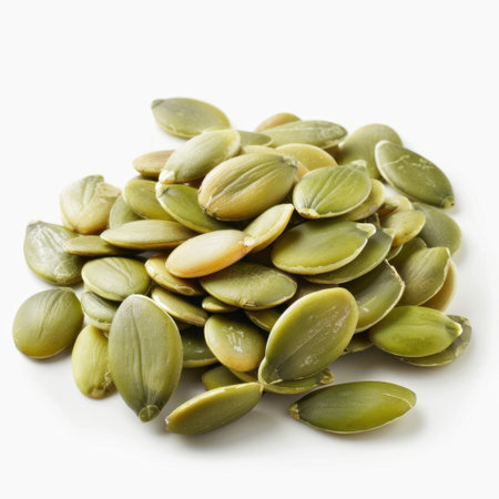 A vibrant pile of fresh green pumpkin seeds on a white background, showcasing their rich texture and potential for use in healthy dishes, snacks, and meals.の素材