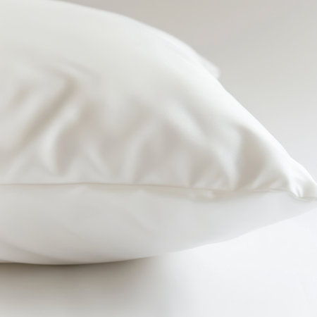A pristine white pillow resting on a light background, showcasing its soft texture and elegant design, perfect for enhancing the cozy atmosphere of any space.の素材