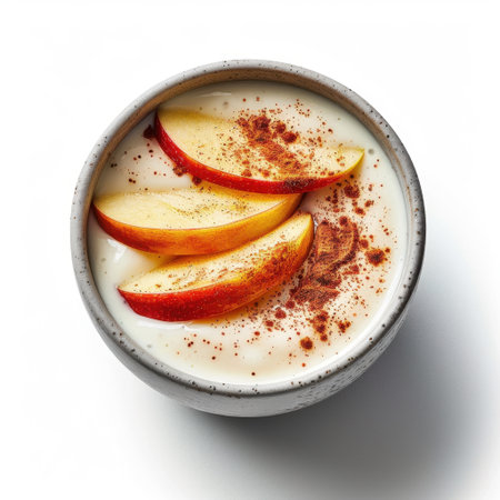 Enjoy a vibrant yogurt bowl featuring fresh apple slices and a sprinkle of cinnamon, ideal for a healthy breakfast or snack. Perfect for food lovers!の素材