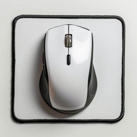 This image features a modern computer mouse placed on a white mouse pad, highlighting ergonomic design and high-quality material. Ideal for gaming or office environments.の素材